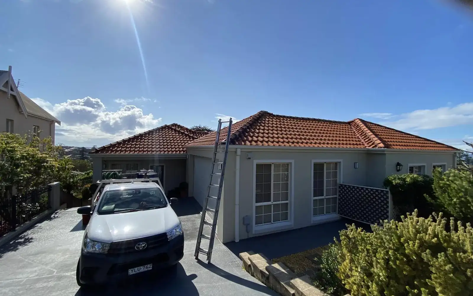 Property maintenance in Jervis Bay by Ed's Property Maintenance with the service ute and ladder set up at a Shoalhaven home