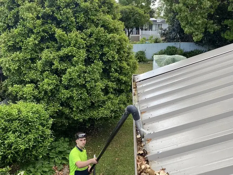 Gutter cleaning by Ed's Property Maintenance in Jervis Bay, vacuuming leaves from a Colorbond roof gutter