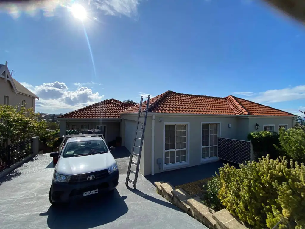 Gutter cleaning at a Kiama home with ladder access to the roof